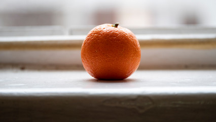 One mandarin on the windowsill