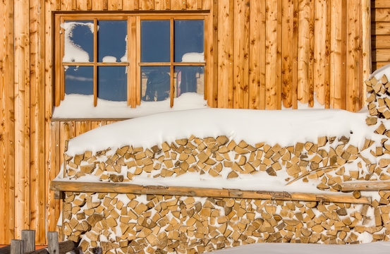 Wooden logs covered by snow