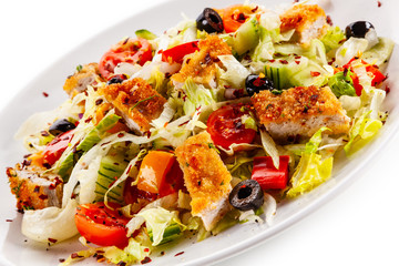 Salad with chicken meat and vegetables on white background