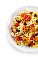 Salad with chicken meat and vegetables on white background