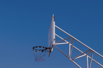 basketball hoop and net against blue sky