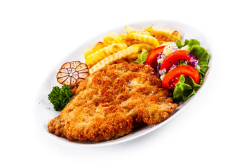 Fried pork chop, French fries and vegetables