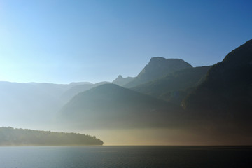 View of mountains over Hallstatt Lake with early morning fog, Austria