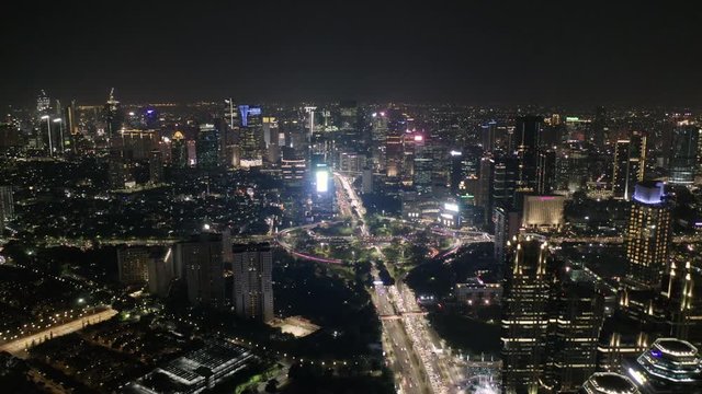Night view of Inner Ring Road and the Sudirman Business District wide angle view. Drone tilt reveal shot.