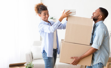Tired Husband Holding Moving Boxes Packing Stuff With Wife Indoor