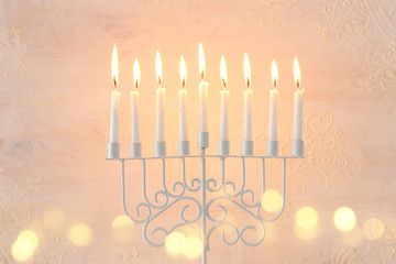 Religion image of jewish holiday Hanukkah background with menorah (traditional candelabra) and candles over white background