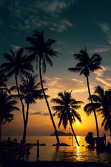 Obraz premium Beautiful poolside and sunset sky. Luxurious tropical beach landscape