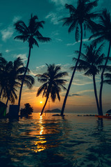 Fototapeta na wymiar Beautiful poolside and sunset sky. Luxurious tropical beach landscape