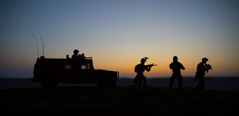 Military patrol car on sunset background. Army war concept. Silhouette of armored vehicle with soldiers ready to attack. Artwork decoration. Selective focus © zef art