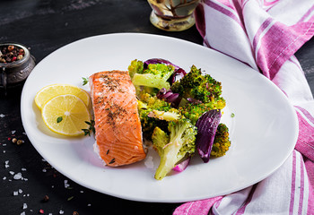 Baked salmon fillet with broccoli, red onion and lemon.