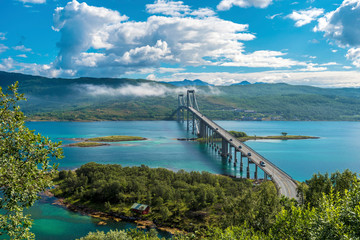 The Tjeldsund Bridge through Tjeldsundet strait viewed from Hinnoya Island, the mainland of Norwegian Troms county is at background.