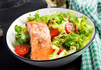 Baked salmon fillet with fresh vegetables salad.