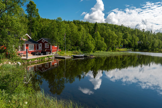 Typical Norvegian house in the border of the lake Lille Trollvatnet.  Nordland, Norway.