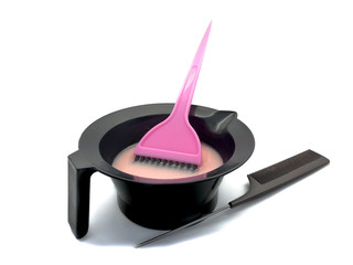 Bowl for paint, brush and comb isolated on a white background. Composition of professional hair dyeing tools. Set Bowl with paint, comb and pink brush for a beauty salon. Hairdresser tools