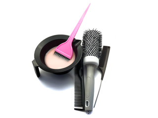 Bowl for paint, brush and comb isolated on a white background. Composition of professional hair dyeing tools. Set Bowl with paint, comb and pink brush for a beauty salon. Hairdresser tools