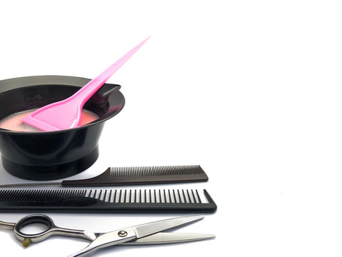 Bowl for paint, brush and comb isolated on a white background. Composition of professional hair dyeing tools. Set Bowl with paint, comb and pink brush for a beauty salon. Hairdresser tools