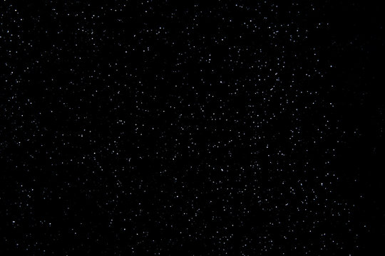 Realistic falling snowflakes. Isolated on black background. © Cosminxp