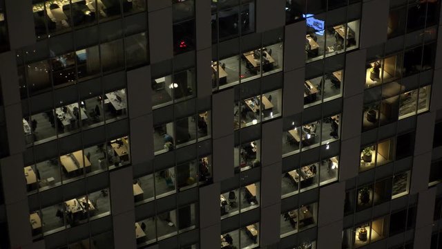 TOKYO, JAPAN : View of exterior of office building at night. Close up shot of glass window.