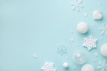 Holiday balls and decorative snowflakes on turquoise pastel background. Christmas or New year card....