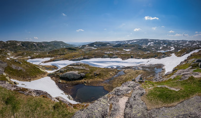 Fototapeta na wymiar Norwegian mountain landscape with blue sky snow and lakes