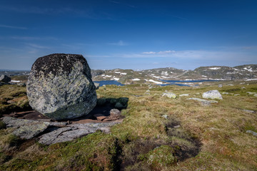 Immens boulder in Norwegian mountain landscape with lakes at mountain pass Suleskard