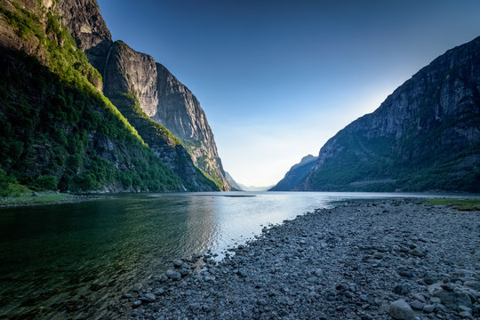 Mouth of Salmon river flows into Lysefjord at dark scenery at dusk Lysebotn Norway