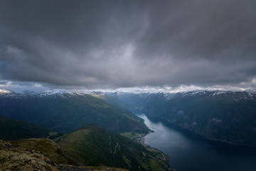 Dark and heavy clouds at Prest viewpoint into fjord and stegastein Norway