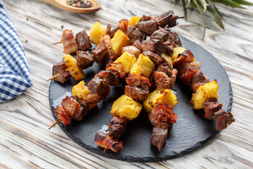 meat kebab with pineapple and bacon