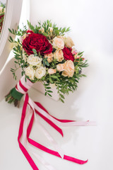 beautiful wedding bouquet with roses and Orchid red cream with ribbons on white background