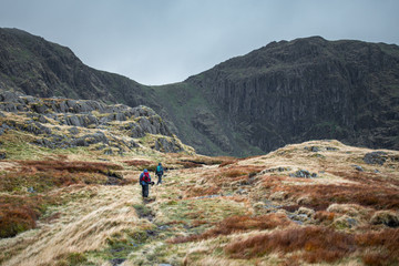 Couple of Hikers Walking Through Mountain Ridge