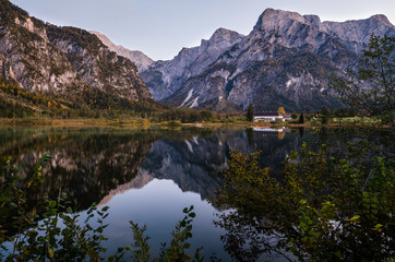 Autumn evening Alps mountain lake with clear transparent water and reflections. Almsee lake, Upper Austria.