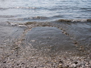 Stone pool for kids on seaside flood with water