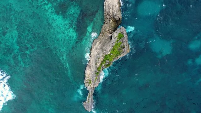 Aerial view at sea and rocks. Turquoise water background from top view. Summer seascape from air. Kelingking beach, Nusa Penida, Bali, Indonesia. Travel - video
