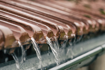 Soft focus storm rain on the roof of the house. - 303301416