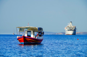 Classic small cruise ship MS Ocean Majesty anchoring in bay on blue sea of Greek Island during...