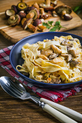 Tagliatelle pasta with forest mushrooms and chicken.