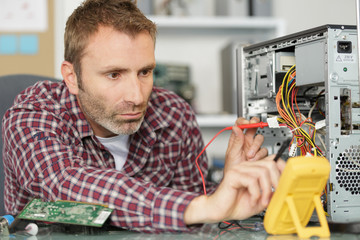 Fototapeta na wymiar a male technician fixing computer