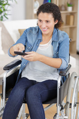 handicapped woman pressing the remote