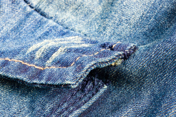 clothing items blue stonewashed faded jeans cotton fabric texture with seams, clasps, buttons and...