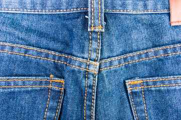 clothing items blue stonewashed faded jeans cotton fabric texture with seams, clasps, buttons and...