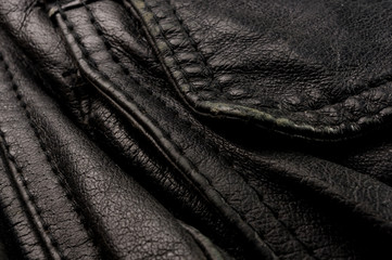 Old vintage genuine soft black leather texture background, top layer with pores and scratches,...