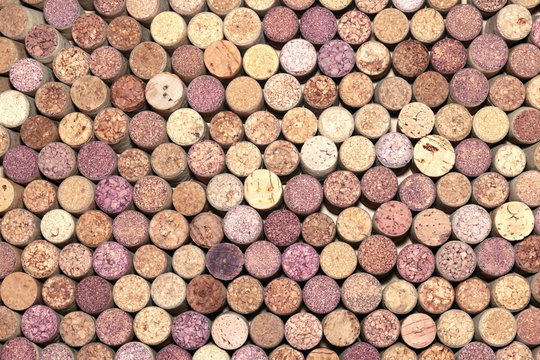 Abstract background of used red and white wine corks with corkscrew