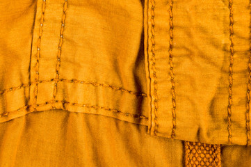 clothing items stonewashed cotton fabric texture with seams, clasps, buttons and rivets, macro