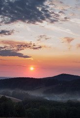 Lázně Libverda, CZECH REPUBLIC - JULY, 17 2019: Sunset in the mountains. Fog in the forest