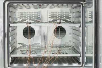 Inside of incubator with thermocouple probes installed for calibtlration in laboratory.