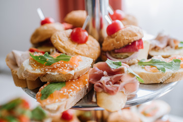 Canapes with red fish on the buffet table
