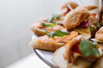 Canapes with red fish on the buffet table