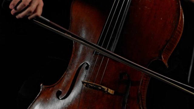 Pretty young woman playing music on string instrument in slow motion,close up