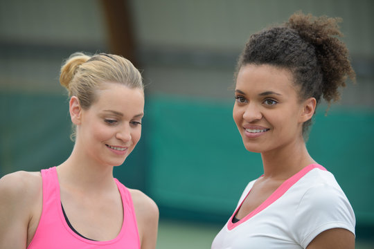 view of two women after running together in the park - Powered by Adobe