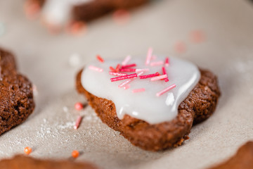 Traditional homemade christmas baking. Christmas gingerbread cookies decorated with icing and pastry decorations. Close-up.